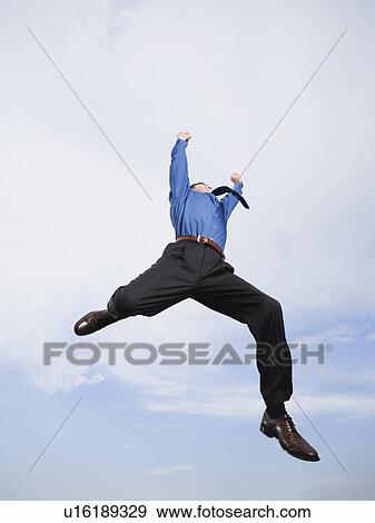 Businessman jumping in mid-air View Large Photo Image Stock Photo - Businessman jumping in mid-air. Fotosearch