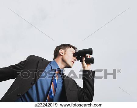 Stock Photo - Businessman looking through binoculars. Fotosearch