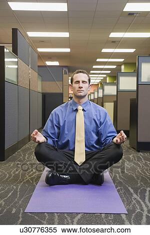 Businessman meditating in office View Large Photo Image Stock Photography - Businessman meditating in office. Fotosearch