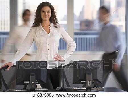 Stock Photography - Businessman posing at desk. Fotosearch