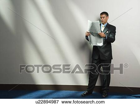 Stock Photo - Businessman reading newspaper. Fotosearch
