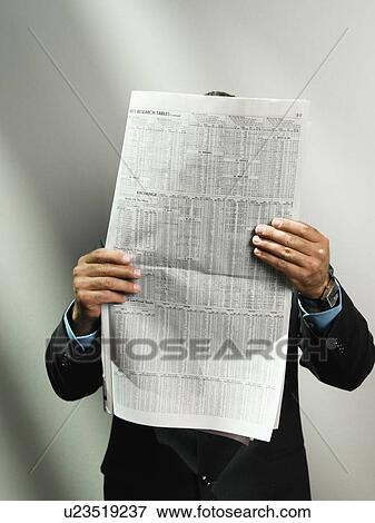 Businessman reading newspaper View Large Photo Image Stock Photo - Businessman reading newspaper. Fotosearch