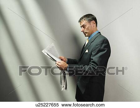 Stock Photography - Businessman reading newspaper. Fotosearch