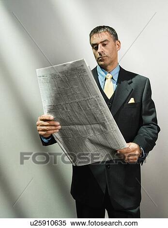 Businessman reading newspaper View Large Photo Image Stock Photography - Businessman reading newspaper. Fotosearch