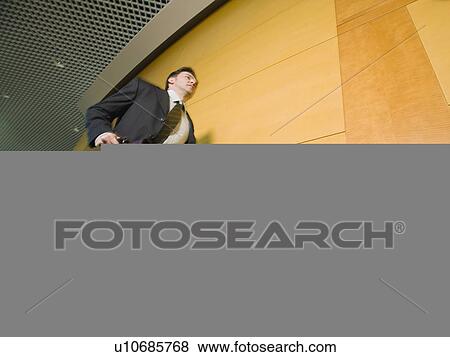 Businessman running in corridor View Large Photo Image Stock Photo - Businessman running in corridor. Fotosearch