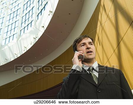 Stock Photograph - Businessman talking on cell phone. Fotosearch