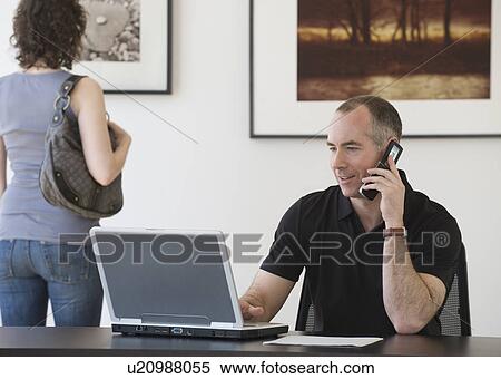 Stock Photography - Businessman talking on cell phone. Fotosearch