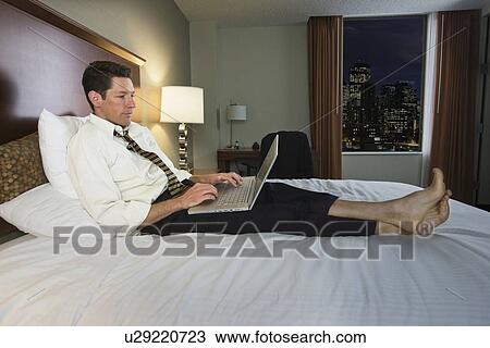 Businessman typing on laptop View Large Photo Image Stock Image - Businessman typing on laptop. Fotosearch
