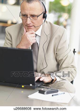 Businessman wearing headset View Large Photo Image Stock Photo - Businessman wearing headset. Fotosearch