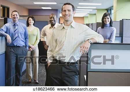 Businessman with multi-ethnic coworkers in background View Large Photo Image Stock Photograph - Businessman with multi-ethnic coworkers in background. Fotosearch