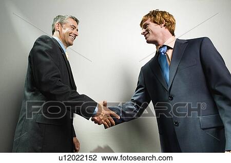 Stock Image - Businessmen shaking hands. Fotosearch