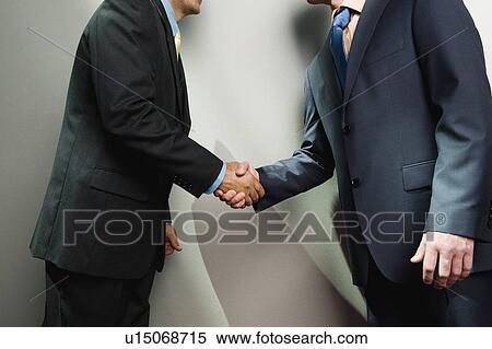 Stock Photography - Businessmen shaking hands. Fotosearch