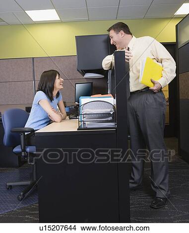 Businesspeople talking over cubicle wall View Large Photo Image Picture - Businesspeople talking over cubicle wall. Fotosearch
