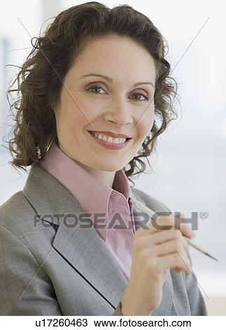 Businesswoman holding pen View Large Photo Image Stock Image - Businesswoman holding pen. Fotosearch