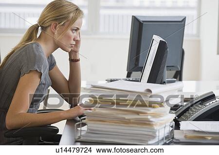 Businesswoman looking at computer View Large Photo Image Picture - Businesswoman looking at computer. Fotosearch