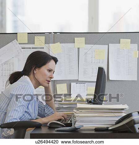 Businesswoman looking at computer View Large Photo Image Stock Image - Businesswoman looking at computer. Fotosearch