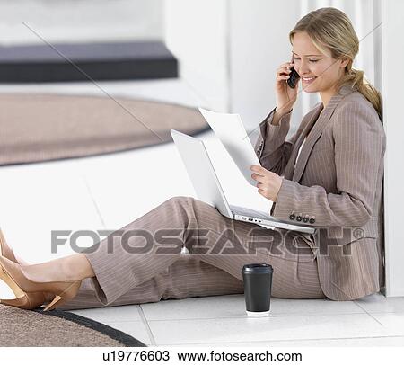 Businesswoman sitting on floor working View Large Photo Image Stock Image - Businesswoman sitting on floor working. Fotosearch