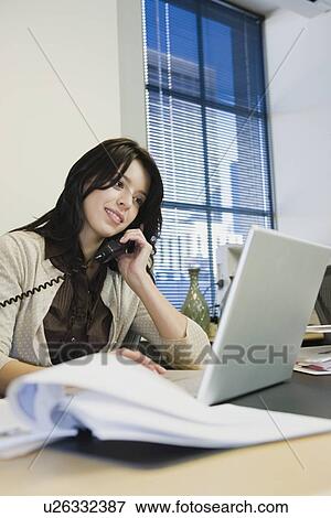 Businesswoman talking on telephone View Large Photo Image Stock Photo - Businesswoman talking on telephone. Fotosearch