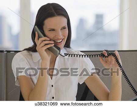Stock Photo - Businesswoman talking on telephone. Fotosearch