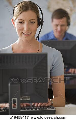 Call center employees working View Large Photo Image Stock Photo - Call center employees working. Fotosearch