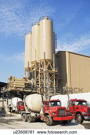 Stock Image - Cement trucks parked at cement plant. Fotosearch