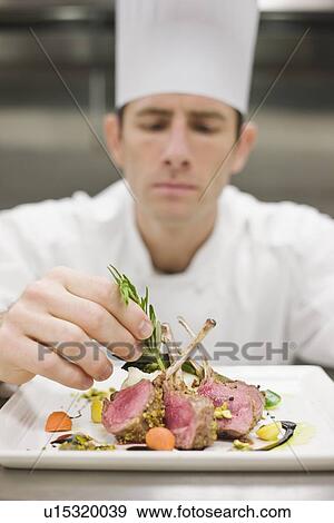 Stock Photo - Chef arranging plate of food. Fotosearch