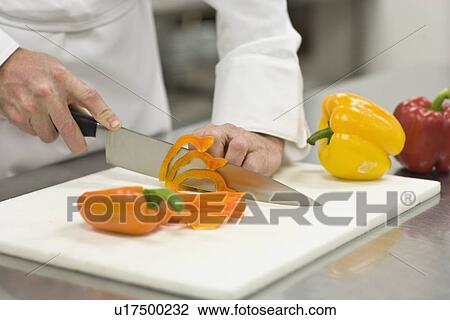 Stock Image - Chef chopping bell peppers. Fotosearch