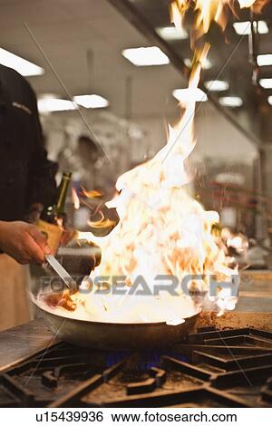 Stock Photograph - Chef cooking with flame. Fotosearch