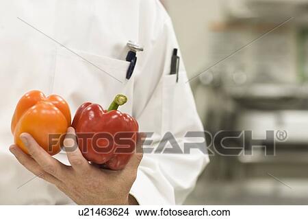 Picture - Chef holding bell peppers. Fotosearch