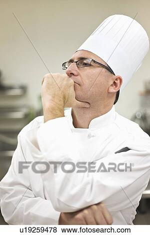 Chef in uniform concentrating View Large Photo Image Stock Photo - Chef in uniform concentrating. Fotosearch
