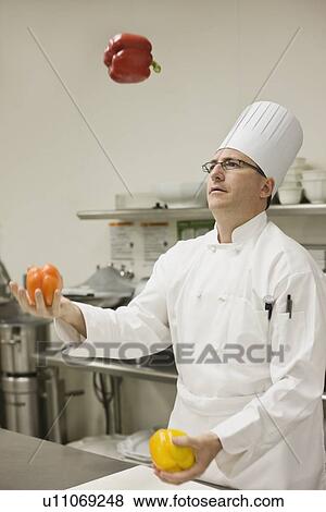 Stock Photo - Chef juggling assorted peppers. Fotosearch