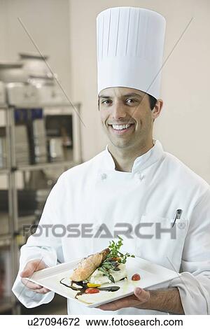 Stock Image - Chef presenting gourmet entree. Fotosearch