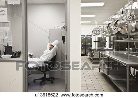 Chef relaxing in kitchen office View Large Photo Image Stock Image - Chef relaxing in kitchen office. Fotosearch