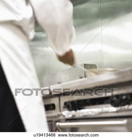 Chef shaking pan on stove View Large Photo Image Stock Photo - Chef shaking pan on stove. Fotosearch