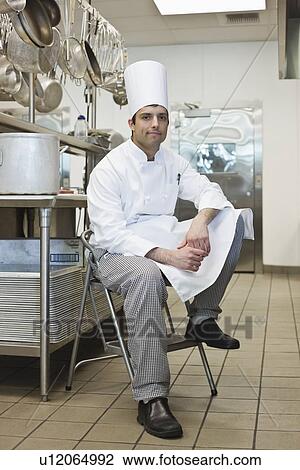 Chef sitting on stool in kitchen View Large Photo Image Stock Image - Chef sitting on stool in kitchen. Fotosearch