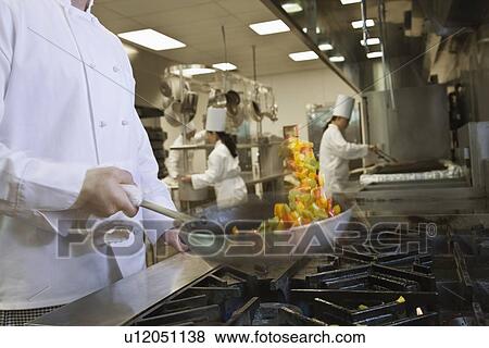 Chef tossing food in skillet View Large Photo Image Stock Photo - Chef tossing food in skillet. Fotosearch