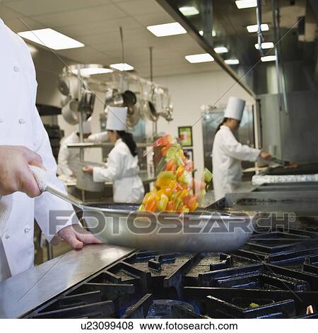 Chef tossing food in skillet View Large Photo Image Stock Photo - Chef tossing food in skillet. Fotosearch