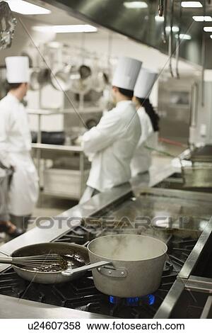 Chefs talking in kitchen View Large Photo Image Stock Photo - Chefs talking in kitchen. Fotosearch