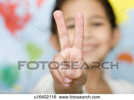 Stock Photograph - Child making peace sign hand gesture. Fotosearch