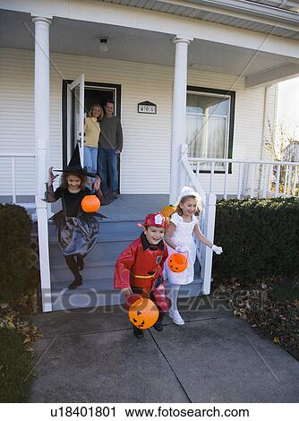 Children dressed in Halloween costumes leaving house View Large Photo Image Stock Image - Children dressed in Halloween costumes leaving house. Fotosearch