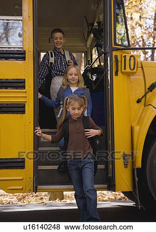 Stock Photo - Children getting off school bus. Fotosearch