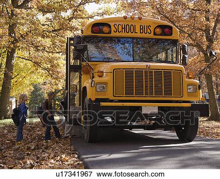Stock Photo - Children getting on school bus. Fotosearch