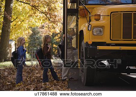 Stock Photo - Children getting on school bus. Fotosearch