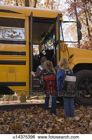 Stock Photograph - Children getting on school bus. Fotosearch