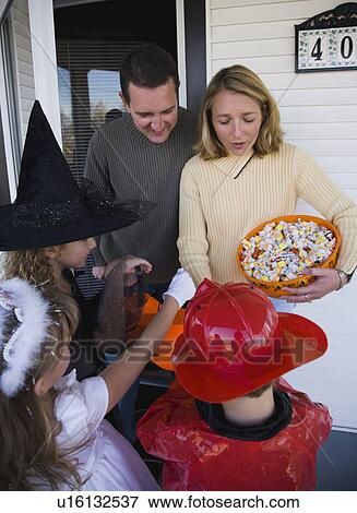 Children in Halloween costumes trick or treating View Large Photo Image Stock Photo - Children in Halloween costumes trick or treating. Fotosearch