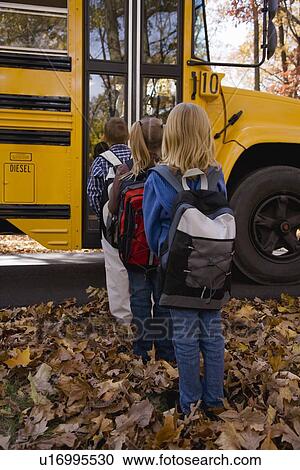 Stock Image - Children in line for school bus. Fotosearch