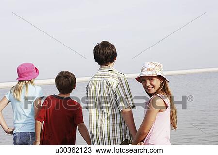 Stock Image - Children looking at ocean view. Fotosearch