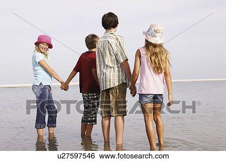 Stock Photograph - Children looking at ocean view. Fotosearch