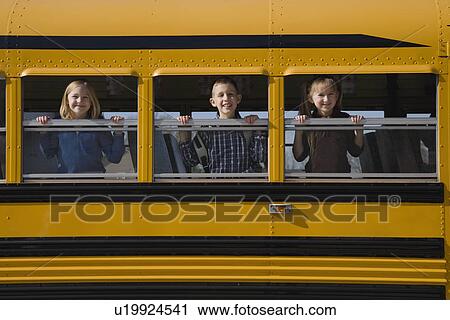 Stock Image - Children looking out school bus windows. Fotosearch
