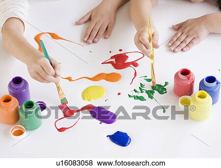 Children painting on table View Large Photo Image Stock Photo - Children painting on table. Fotosearch